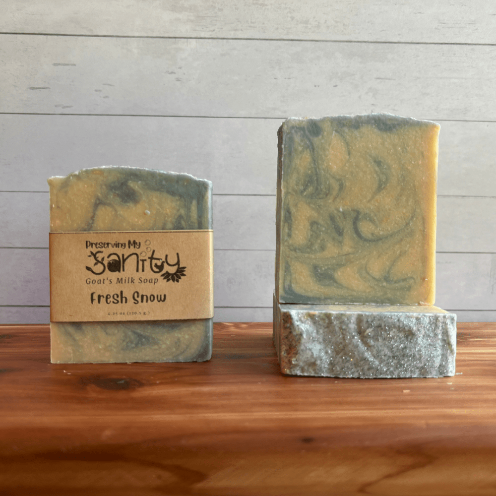 Photo of three bars of Fresh Snow goat milk soap arranged to show different angles and parts of handcrafted soap bars