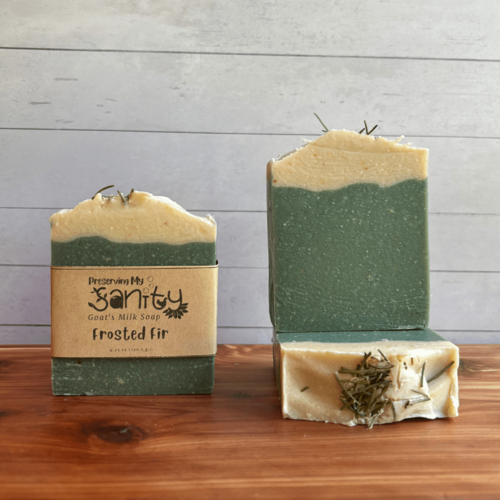 Photo of three bars of Frosted Fir goat milk soap arranged to show different angles and parts of handcrafted soap bars