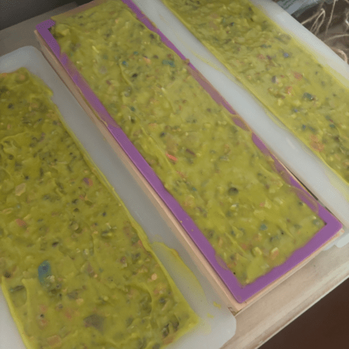 Process photo showing three loaves of freshly poured Kitchen Sink confetti goat milk soap