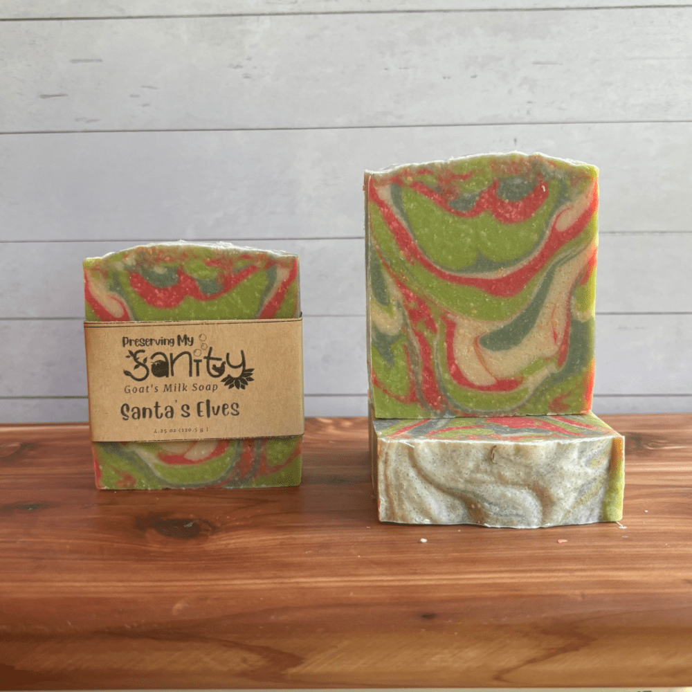 Photo of three bars of Santa's Elves goat milk soap arranged to show different angles and parts of handcrafted soap bars