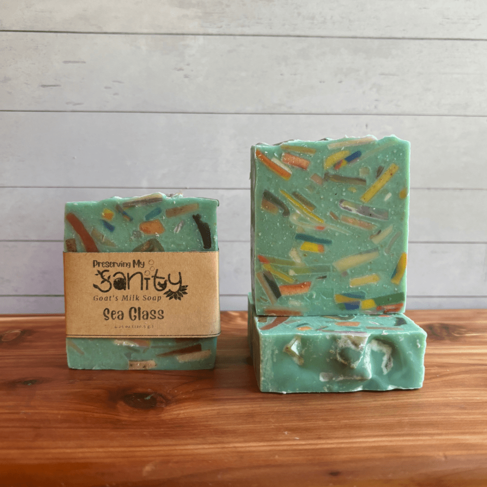 Photo of three bars of Sea Glass goat milk soap arranged to show different angles and parts of handcrafted soap bars