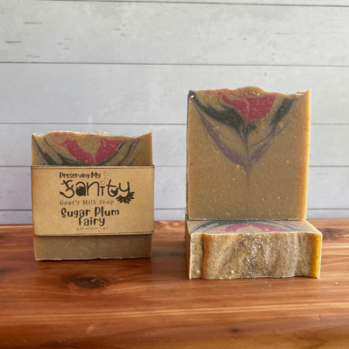 Photo of three bars of Sugar Plum Fairy goat milk soap arranged to show different angles and parts of handcrafted soap bars