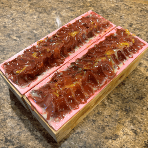 Process photo showing two freshly poured loaves of Cowboy goat milk soap with pretty textured tops