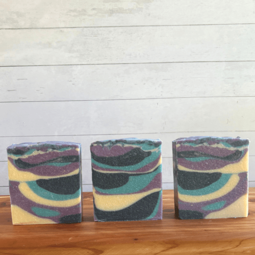 Alternate front view photo showing three bars of Frozen Lake goat milk soap, this one doesn't have any labels to show off the swirls