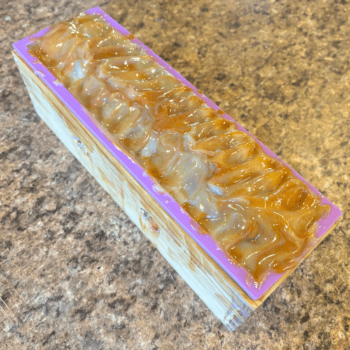 Process photo sohwing a freshly poured loaf of Lavender Lemongrass goat milk soap