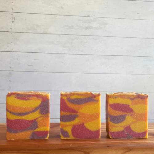 Alternate front view photo of three bars of Nag Champa goat milk soap without labels to showcase the swirl patterns