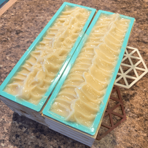 Process photo showcasing two loaves of freshly poured plain unscented goat milk soap