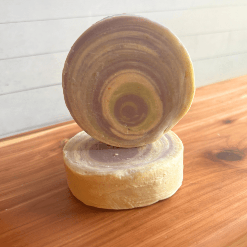 Alternate view photo of two round bars of White Tea and Lily goat milk soap