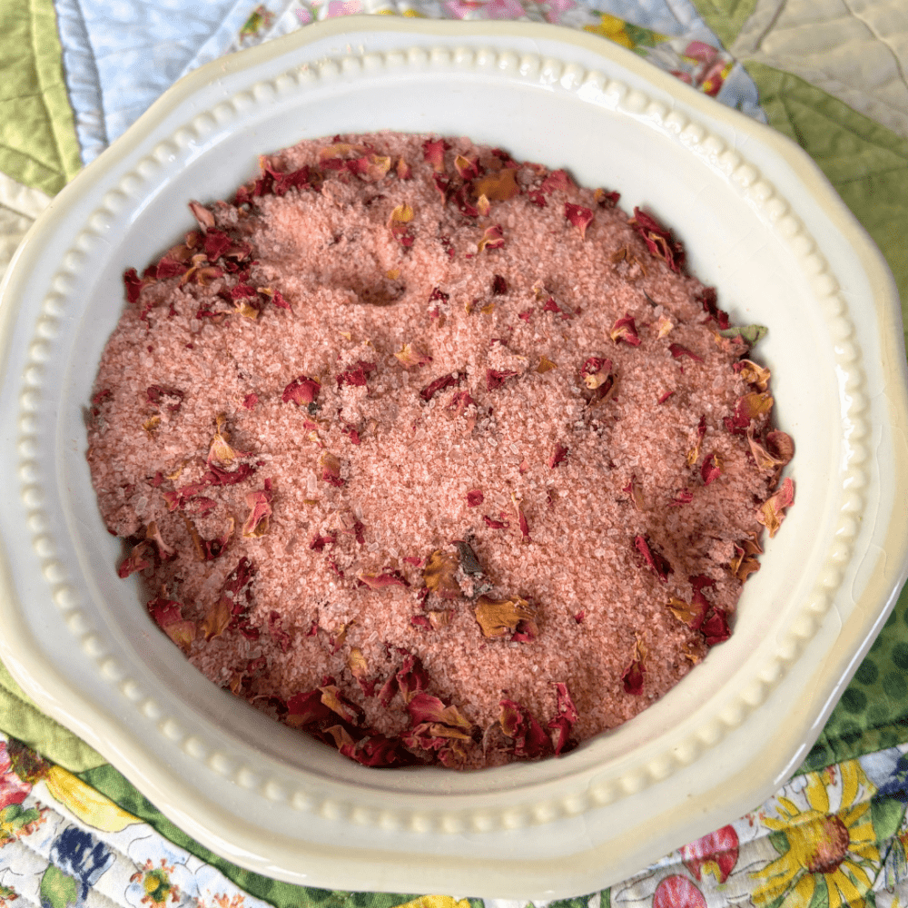 Pretty white bowl filled with rose bath tea, sitting on a spring tablecloth