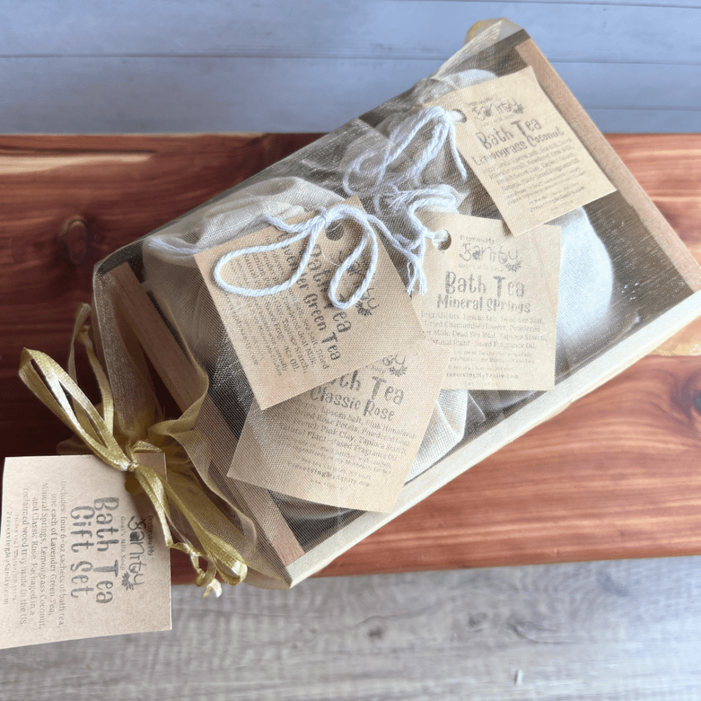 Reclaimed wood crate containing four sachets of bath tea scents, packaged in a gold organza bag and ready for gifting