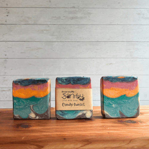 Display photo showing three bars of Candy Sunset goat milk soap. Pictured to show the 16 colors of this creation that was inspired by one of my favorite painitngs, this was my entry for the April Soap Challenge Club. Scented with a fresh beachy scent, grab one now while this limited edition soap lasts!