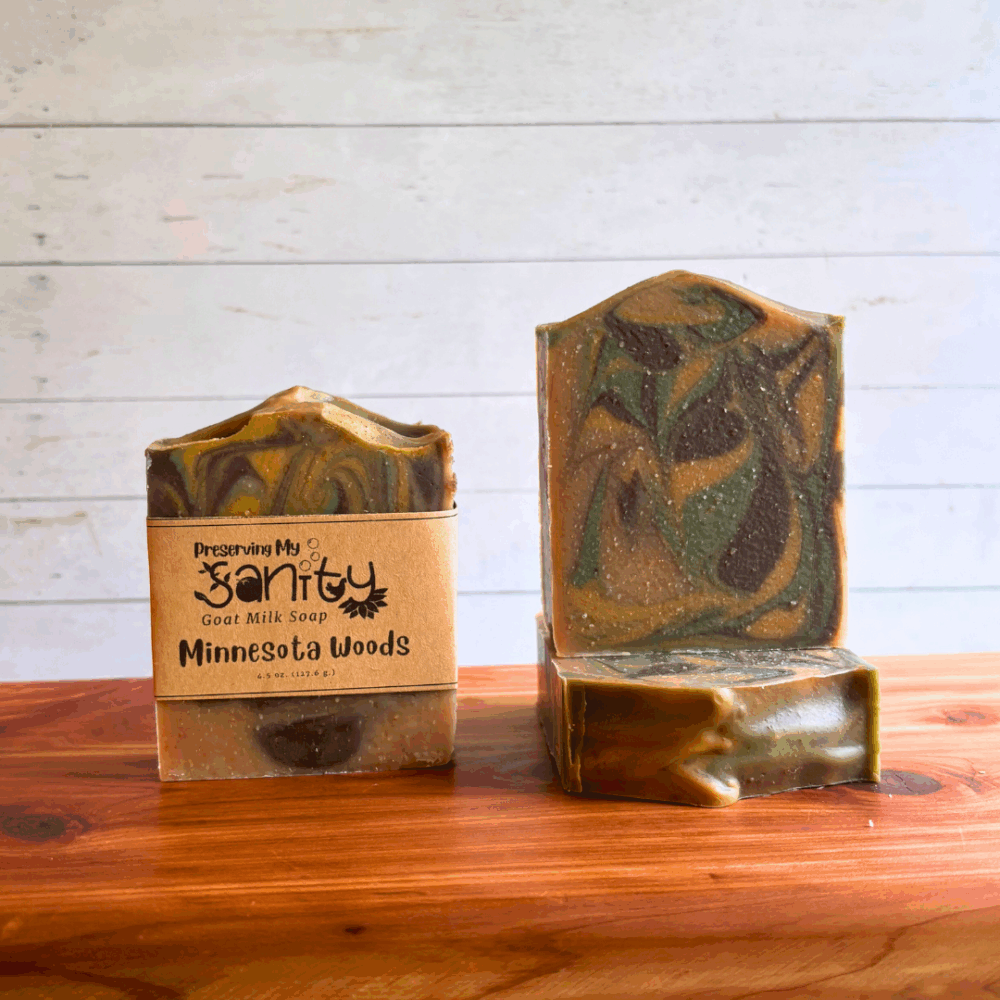 Three bars of Minnesota Woods goat milk soap. This soap has calming swirls of beige, brown, green, and gold and this bestselling soap is part of my fall collection (though I usually make it available year-round because it's one of my personal favorites.) Two bars are displayed to show the design and top of the bars, while the third shows the label.
