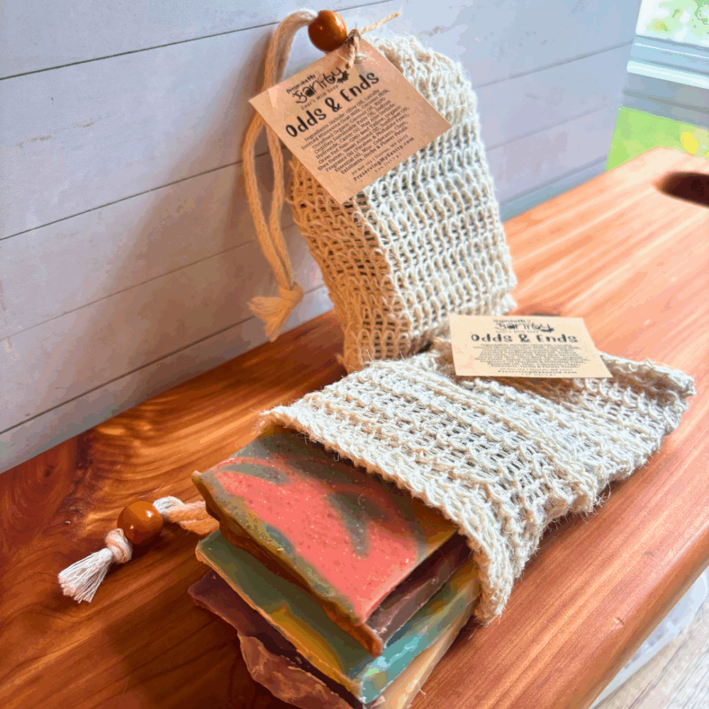 Photo of two Odds & Ends samplers of goat milk soap - one to show packaged look of the sampler, the other opened to show the contents that are in the bag (5 ounces of goat milk soap)