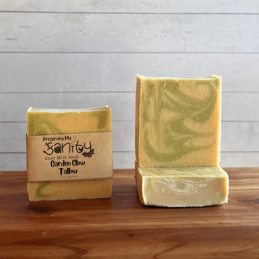 Three bars of Garden Glow Tallow soap, made with natural colorants, essential oils, and locally sourced Minnesota goat milk. The soap design is an uncolored batter with light green swirls.