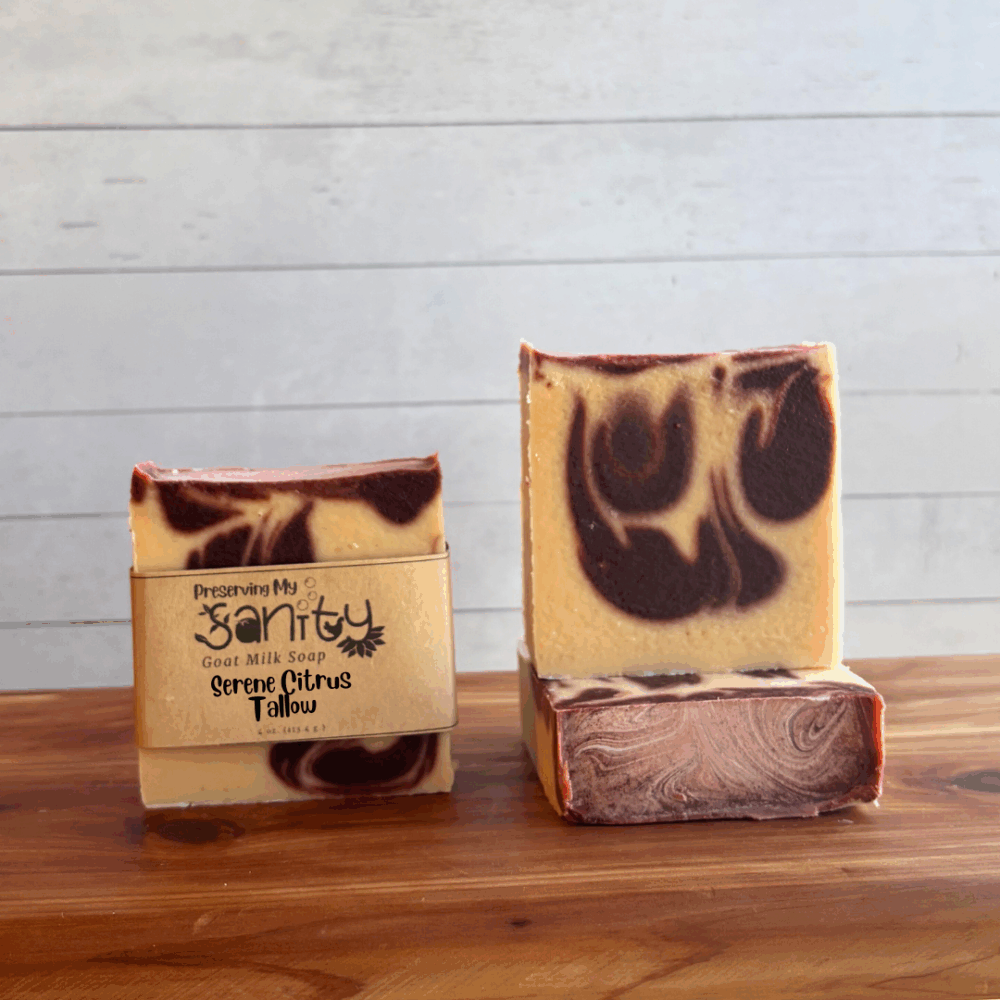 Three bars of Serene Citrus tallow soap, made with natural colorants, essential oils, and locally sourced Minnesota goat milk. Soap design is an uncolroed batter with dark red swirls.